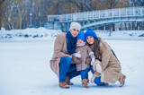Portrait of a family on the background of a frozen lake in the park