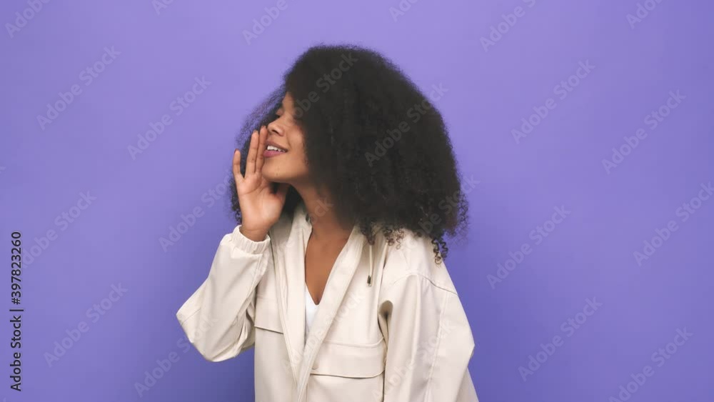 Young african american curly woman pointing with finger at you as if inviting come closer Young african american curly woman pointing with finger at you as if inviting come closer