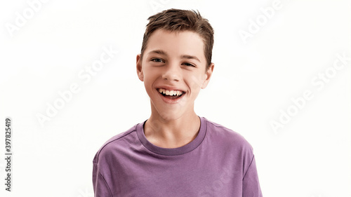 Close up portrait of happy teenaged disabled boy with cerebral palsy smiling at camera, posing isolated over white background