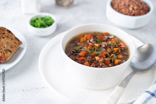 Green Lentil carrots red pepper vegan soup in a bowl