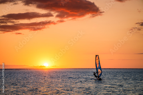 Tableau sur toile Man windsurfing at sunset on Reunion Island