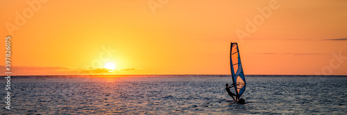 Man windsurfing at sunset on Reunion Island