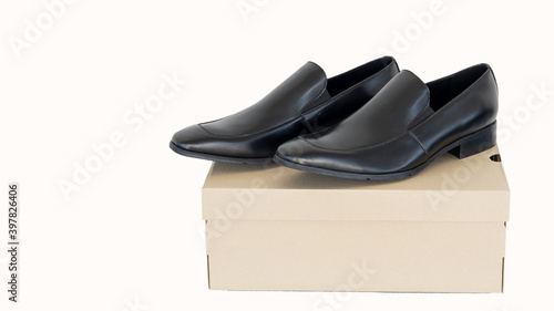 Black leather shoes in a men's shoe boutique with an isolated box on a white background.
