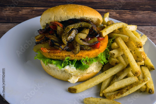 chiken patty sandwich with peppers and onions
