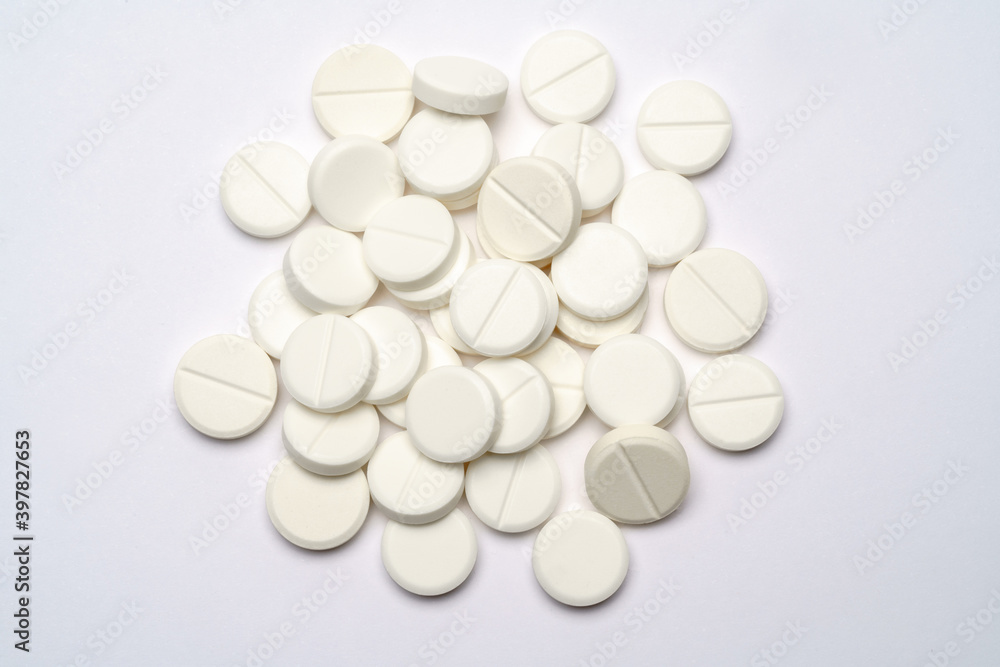 Heap of pills tablets over light grey background Heap of pills tablets over light grey background