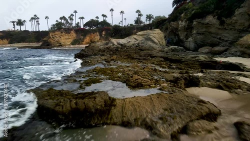 Low flying over rocks while increasing altitude at Laguna Beach, CA photo