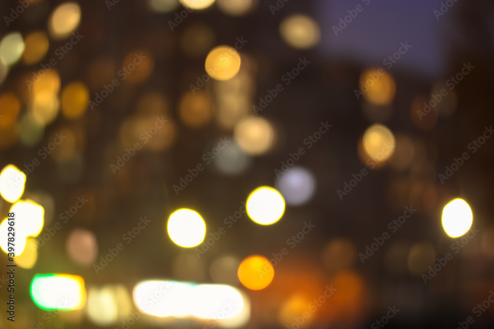 The facade of the apartment building, blurred light in the windows at night The facade of the apartment building, blurred light in the windows at night