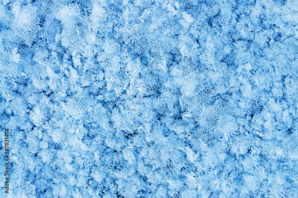 Winter or Christmas background with snow patterns, crystals close-up and snowflakes. Natural snow frosty background with copy space, frozen, abstract, wallpaper, texture surface