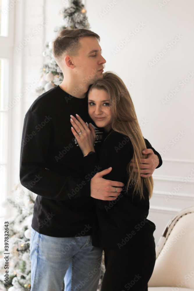 Married couple celebrate Christmas and New Year in front of Christmas tree Married couple celebrate Christmas and New Year in front of Christmas tree