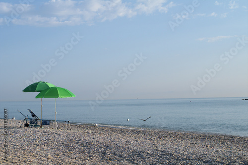 beach with umbrellas summer  sky  parasol travel  water  coast  holiday  sun relax  tourism 