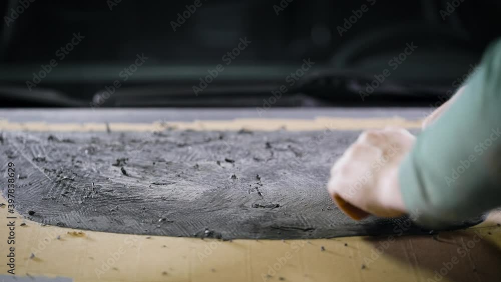 A close-up of a man's hand with a tool. A professional removes the form from the clay with the help of a cycle. The production A close-up of a man's hand with a tool. A professional removes the form from the clay with the help of a cycle. The production