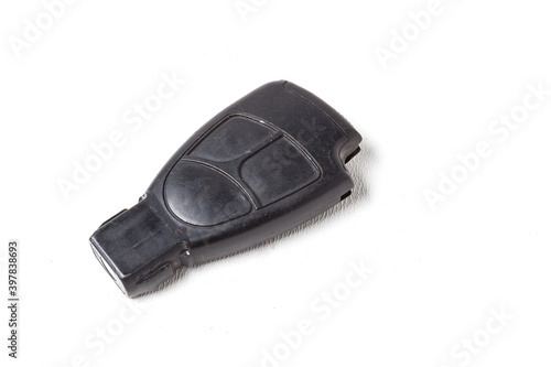 Car key with a chip and with buttons for opening and closing the central locking control, isolated on a white background in a photo studio.
