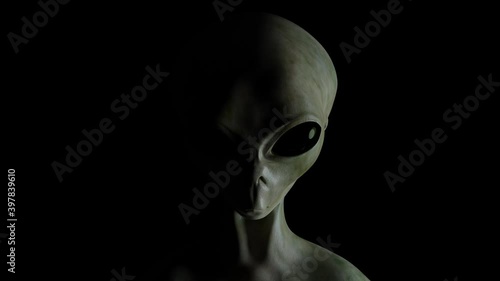 Spooky alien's face on black background. UFO and extraterrestrial life concept.