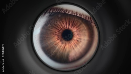 Curious man is looking through peephole in door. Privacy and security concept. Close-up view on eye. photo