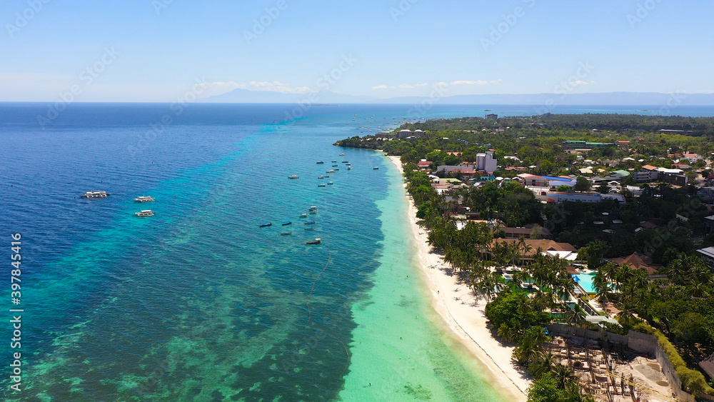Beautiful Alona beach and blue sea in Panglao island, Bohol, Philippines. Holiday and vacation concept. Tropical beach.