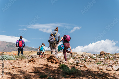 Group of Tourists in Summer Mountain Landscape. Travel location of popular attraction. View of beautiful nature.