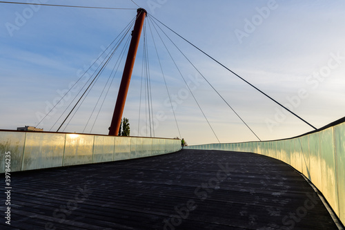 Pathway on the suspended bridge from Drumul Taberei Park, also known as Moghioros Park, in Bucharest,  Romania, at sunrise in an autumn morning. photo