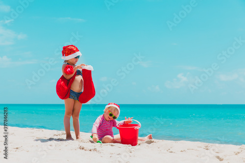 cute little girls celebrating christmas on tropical beach