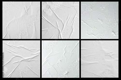 Six sheets of crumpled paper with folds on a black background.