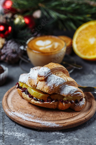 New Year's breakfast with croissants. New Year's croissant with chocolate and baked orange