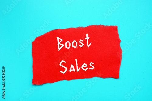 Business concept meaning Boost Sales with inscription on the piece of paper.