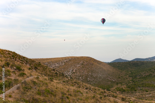Balloons in the cloudy sky mountain landscape
