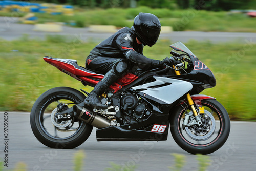 Motorcycle practice leaning into a fast corner on track