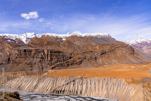 Serene Landscape of Spiti river valley with gully eroded and pinnacle geological weathered landform in cold desert arid region of Trans Himalayas Lahaul and Spiti district of Himachal Pradesh, India. photo