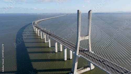4k drone Aerial view of architectural landmark Vasco da Gama Bridge over the Tagus River at dusk in Lisbon, Portugal. The Vasco da Gama Bridge is the longest bridge in the European Union