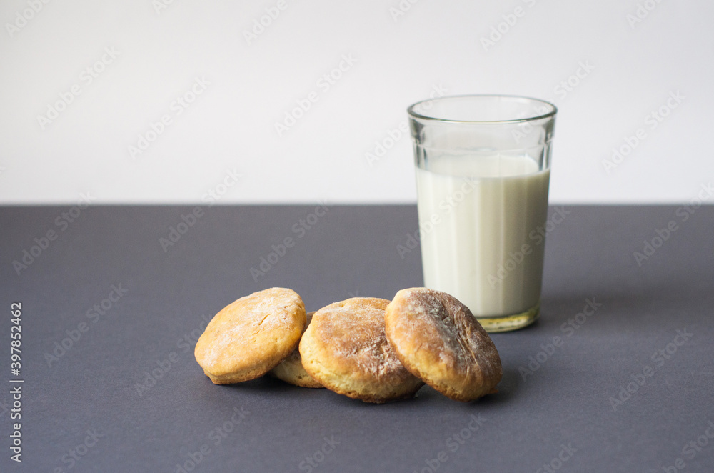 Milk and cookie. homemade shortcake and a glass of milk on the table on a white background Milk and cookie. homemade shortcake and a glass of milk on the table on a white background