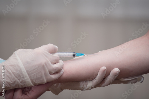 Close-up hands nurses are vaccinations to patients using the syringe.Doctor vaccinating women in hospital.Are treated by the use of sterile injectable upper arm. injection antibody influenza vaccine