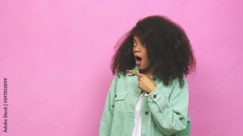 Young african american curly woman pointing to the side Young african american curly woman pointing to the side