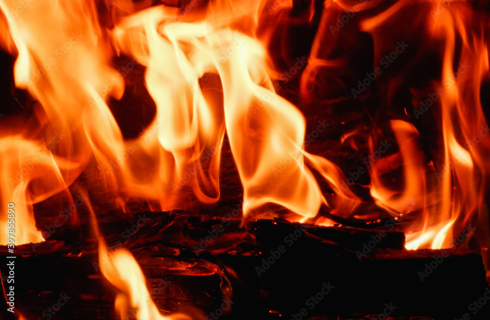 Abstract fire flame in fireplace, texture for background. Beautiful bright orange flames flicker in the darkness of the night. Abstract fire flame in fireplace, texture for background. Beautiful bright orange flames flicker in the darkness of the night.