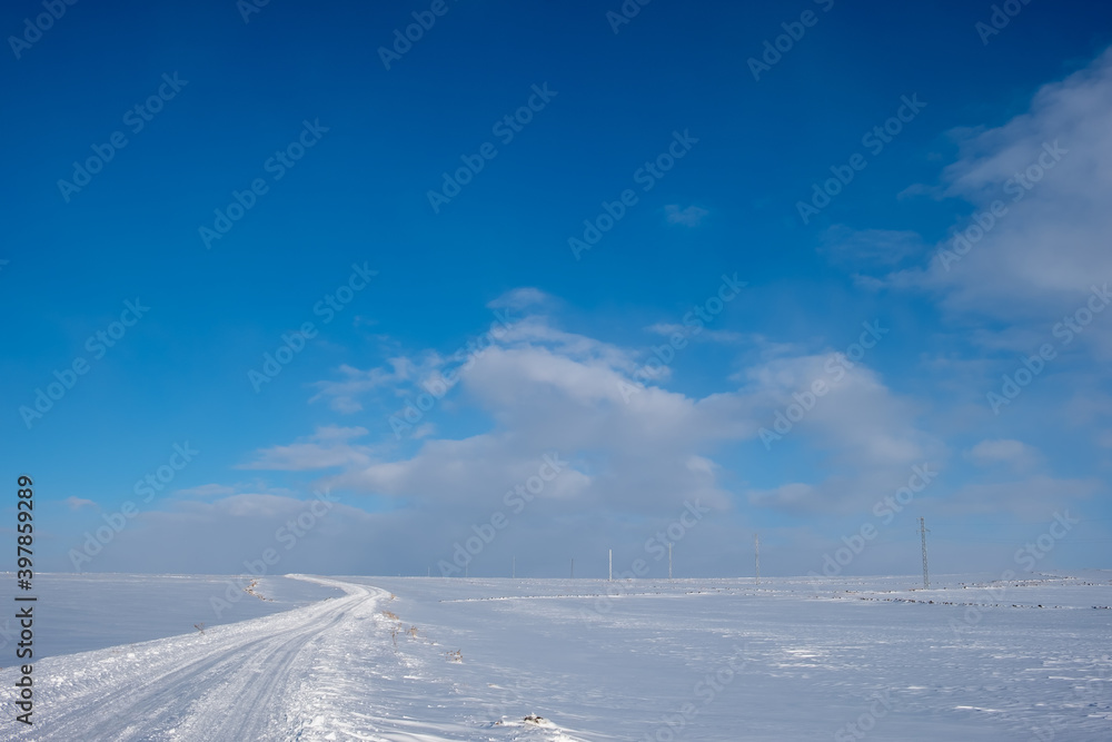 snow covered road at winter sunny day