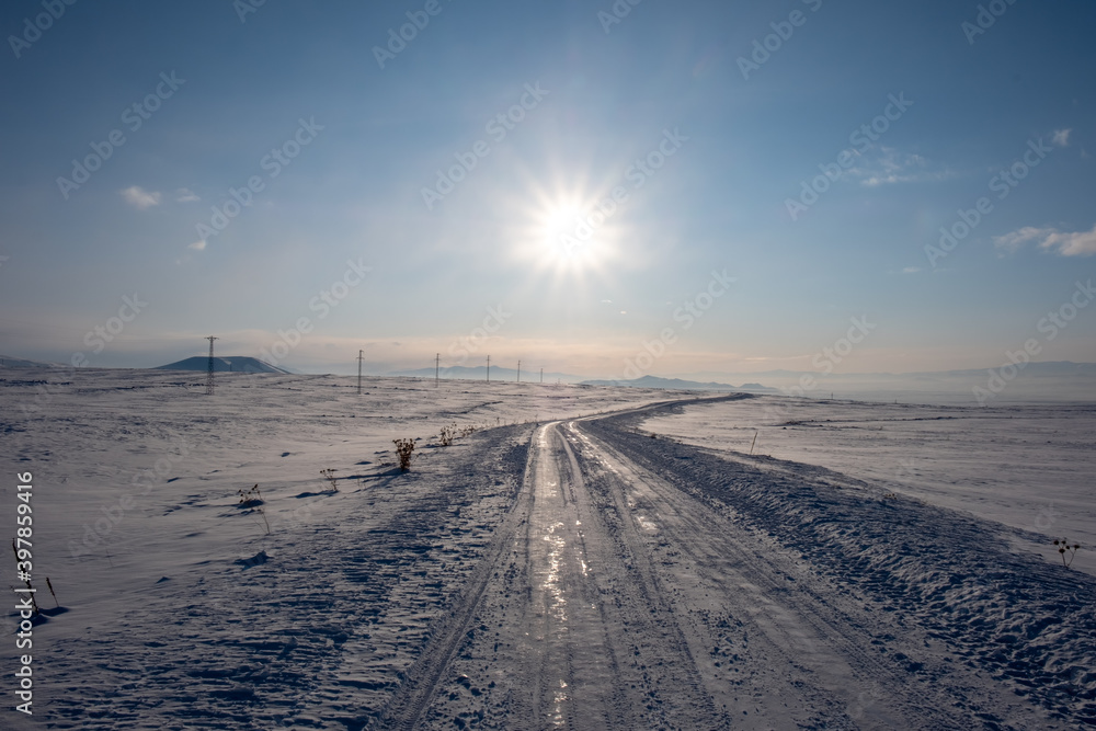 snow covered road at winter sunny day
