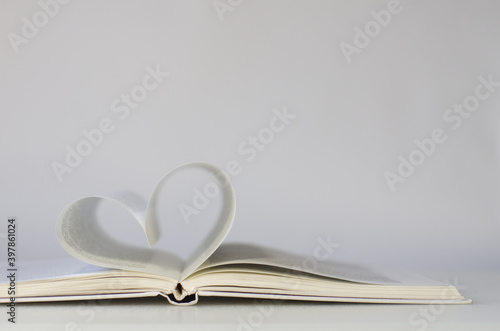 Close-up of book pages folded into a heart shape. Love of reading.