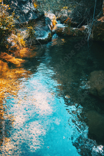 Fototapeta Naklejka Na Ścianę i Meble -  Small crystal clear waterfall inside the forest on a mountain in Prades, Spain.