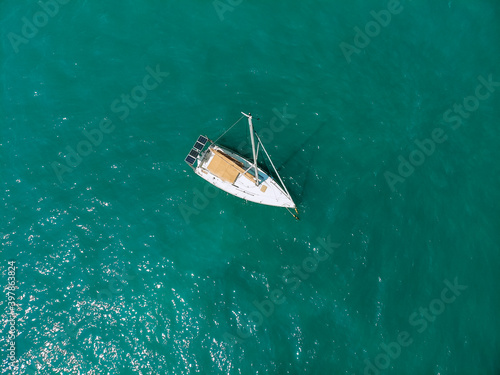 Picturesque top view of a huge white yacht sailing across the deep sea. Aerial view. © Semachkovsky 