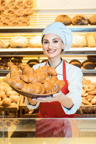 Sales woman offering fresh pastries