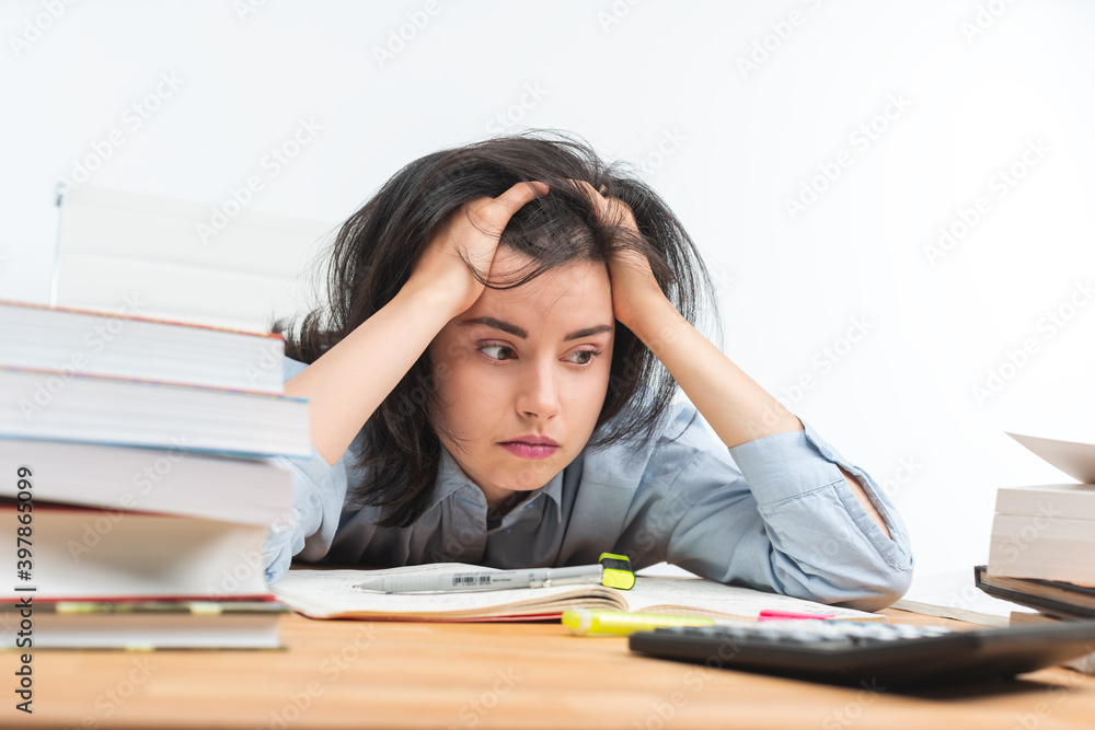 Depressed teenage girl with books Depressed teenage girl with books