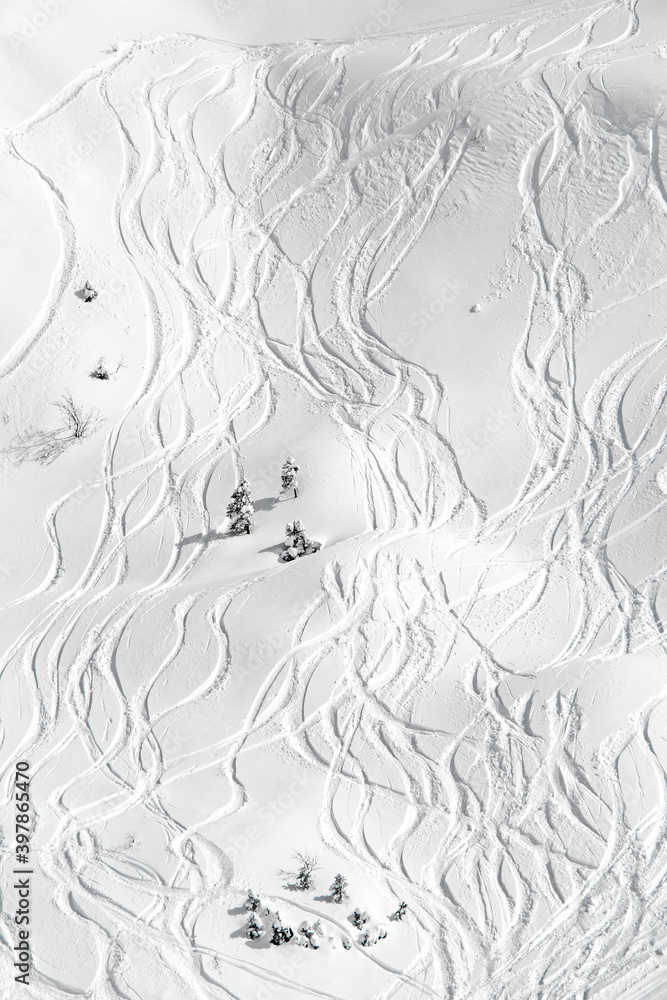 Ski traces on snow in mountains at sunny day Ski traces on snow in mountains at sunny day