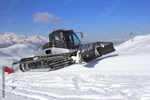 Snow groomer on a skiing slope in action