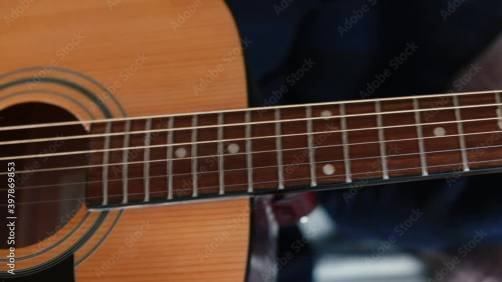 African American hands play the guitar. The technique of hitting the strings. He is exploring new uses for a musical instrument. Camera movement. African American hands play the guitar. The technique of hitting the strings. He is exploring new uses for a musical instrument. Camera movement.