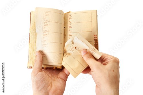 Hands of man tearing page out of notebook close-up