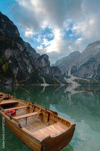 Italy. Dolomites mountains and a boat in Braes lake   Autumn landscape.