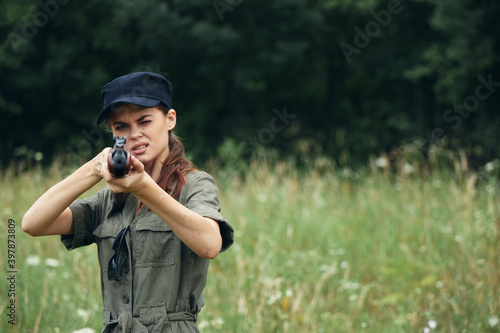 Military woman aiming forward with a weapon lifestyle black cap 