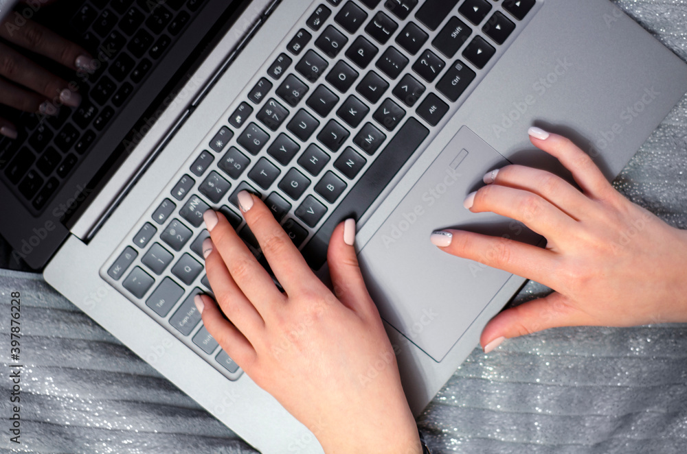 The girl is typing on the keyboard. View from above. The girl is typing on the keyboard. View from above.