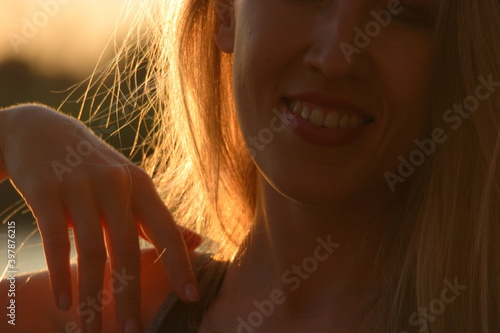 Part of the face of smiling lady. Ecstatic emotions backlit. photo