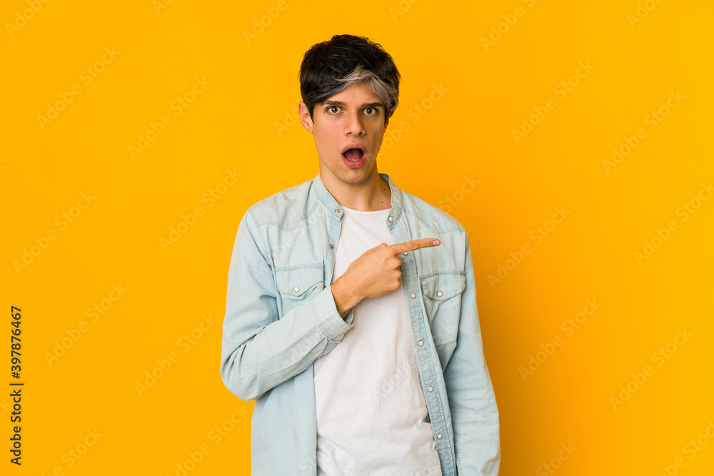 Young skinny hispanic man pointing to the side Young skinny hispanic man pointing to the side
