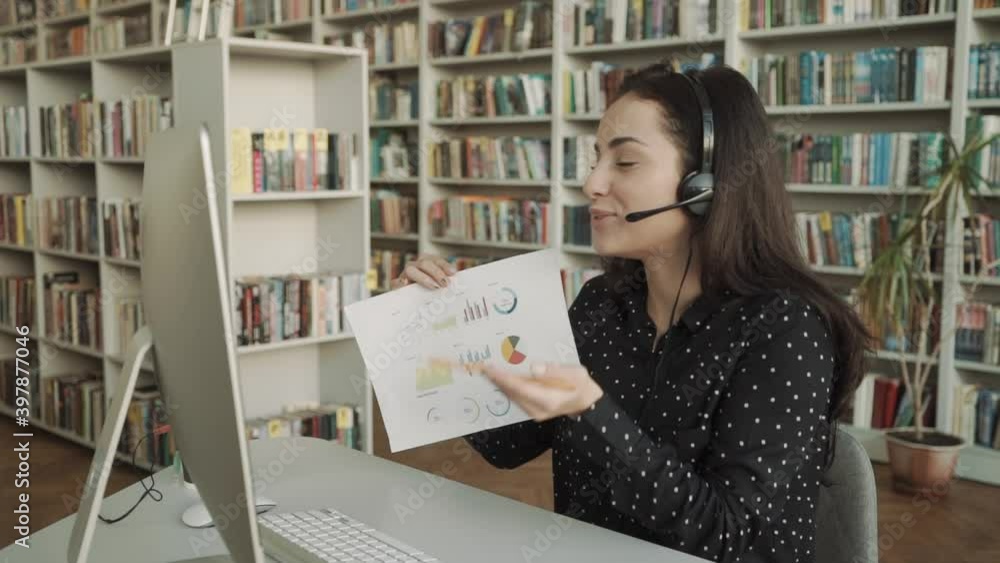 consulting online, young beautiful woman demonstrates on web camera financial reports consulting online, young beautiful woman demonstrates on web camera financial reports